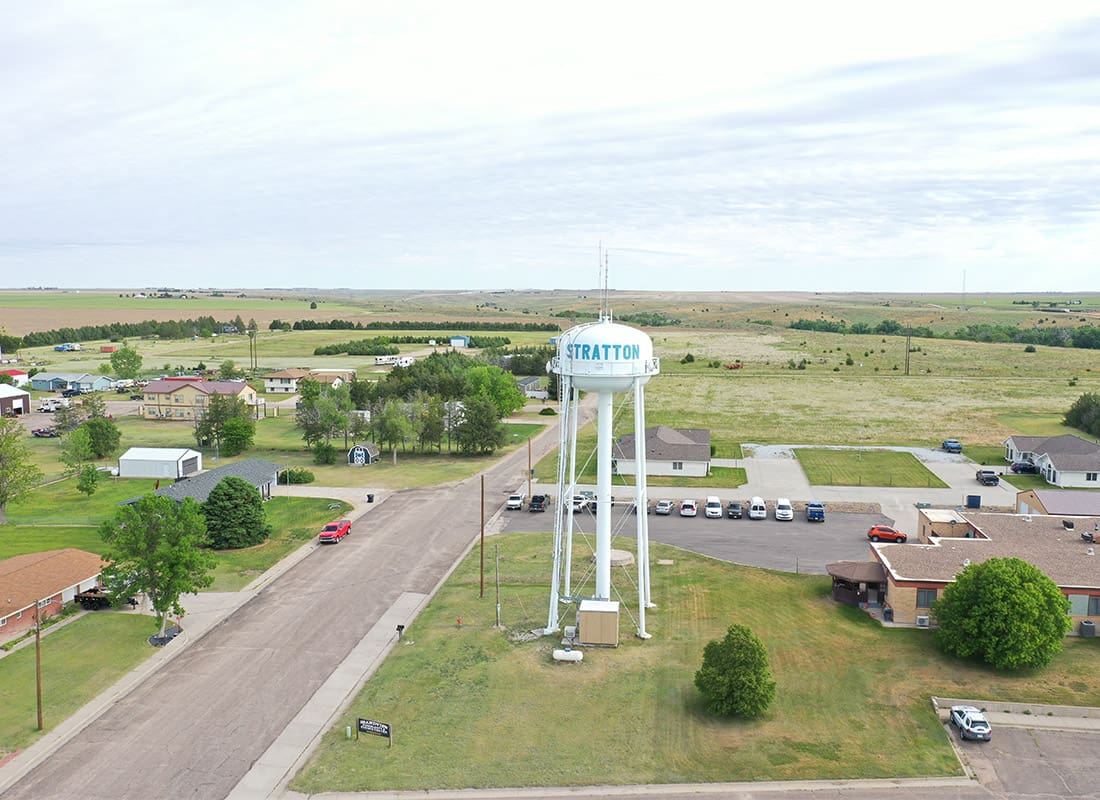 Stratton, NE - Clear Blue Sky Overlooking a Water-Tower in the Middle of Town